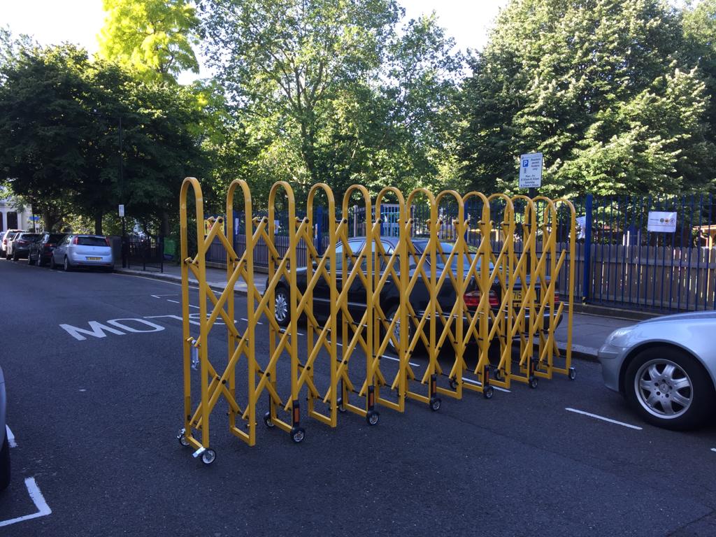 [Photo] temporary collapsible barrier closing a street to traffic